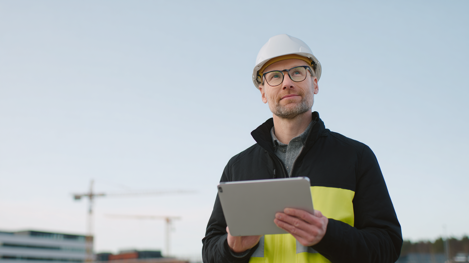 A technical specialist with a tablet in an industrial operations environment